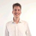 A smiling young man in a white shirt, professional portrait for Involv intranet site.